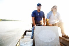 Julius Gaudet, 62, (L) and Rebel (R) glide over the tranquil surface early in the morning as they begin their day hunting for alligators near Shell Island, Louisiana on September 19, 2009