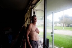 Julius stands in the doorway of his garage after a day of hunting.